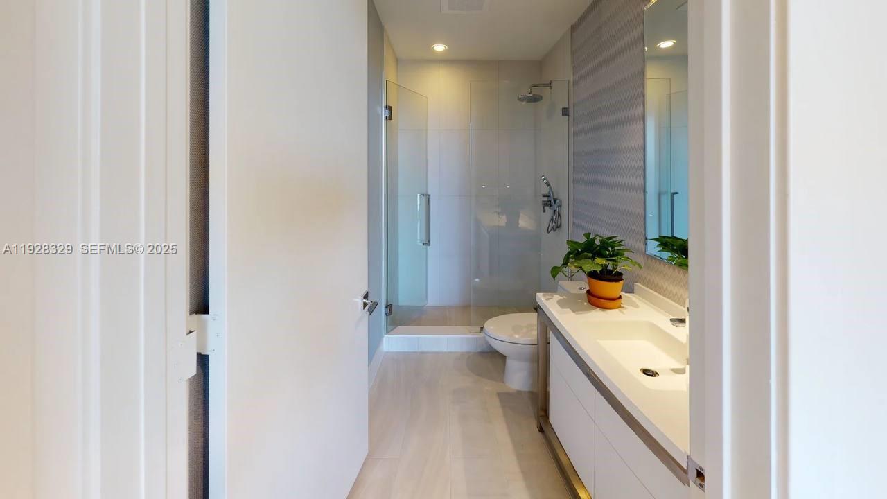 2000 Metropica Way, Unit 1701 Sunrise, FL 33323 - Photo 10 of 32 a spacious bathroom with a shower and a toilet