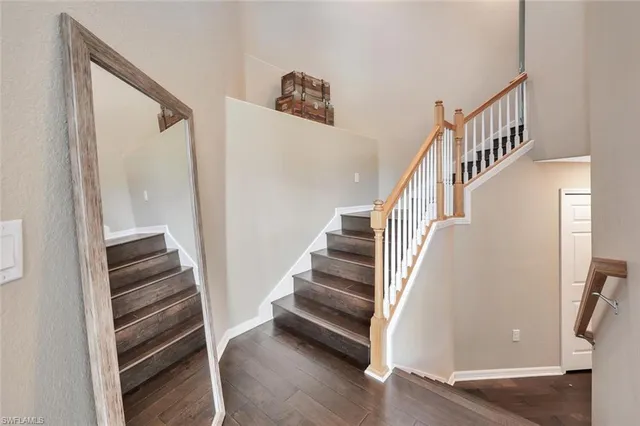 a view of entryway and hall with wooden floor