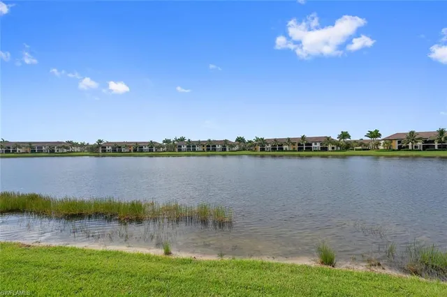 a view of a lake with houses in the back