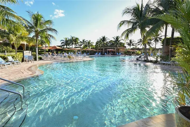 a view of swimming pool with a table and chairs
