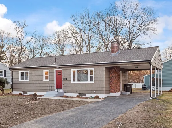 a front view of a house with yard and parking space