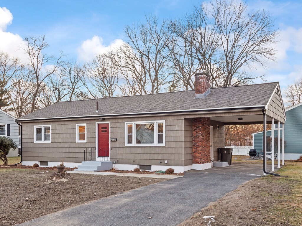 1 Foley Drive Framingham, MA 01701 - Photo 1 of 17 a front view of a house with yard and parking space