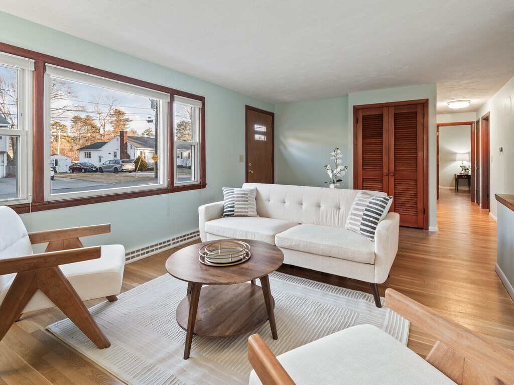 1 Foley Drive Framingham, MA 01701 - Photo 2 of 17 a living room with furniture a couch and paintings on the wall