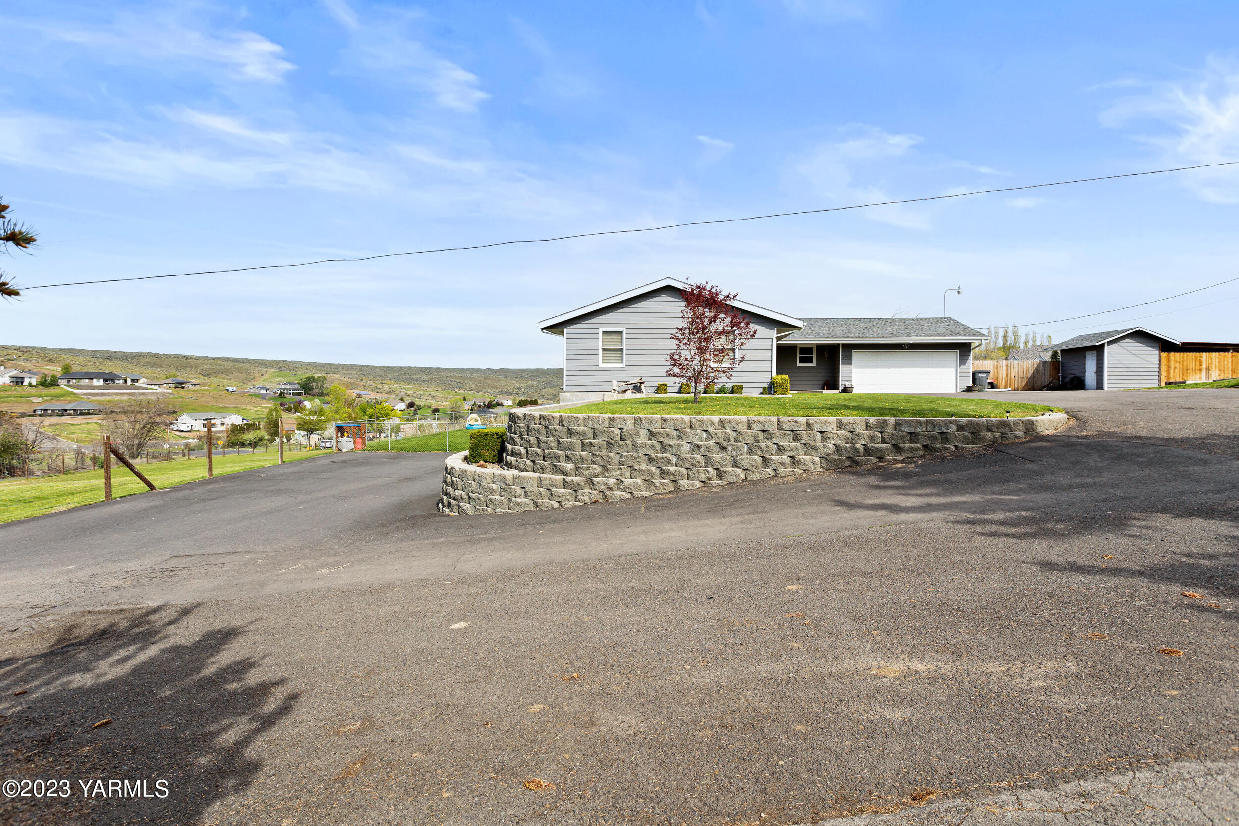 11902 Marble Road Yakima, WA 98908 - Photo 18 of 29 a view of a house with a yard and garage