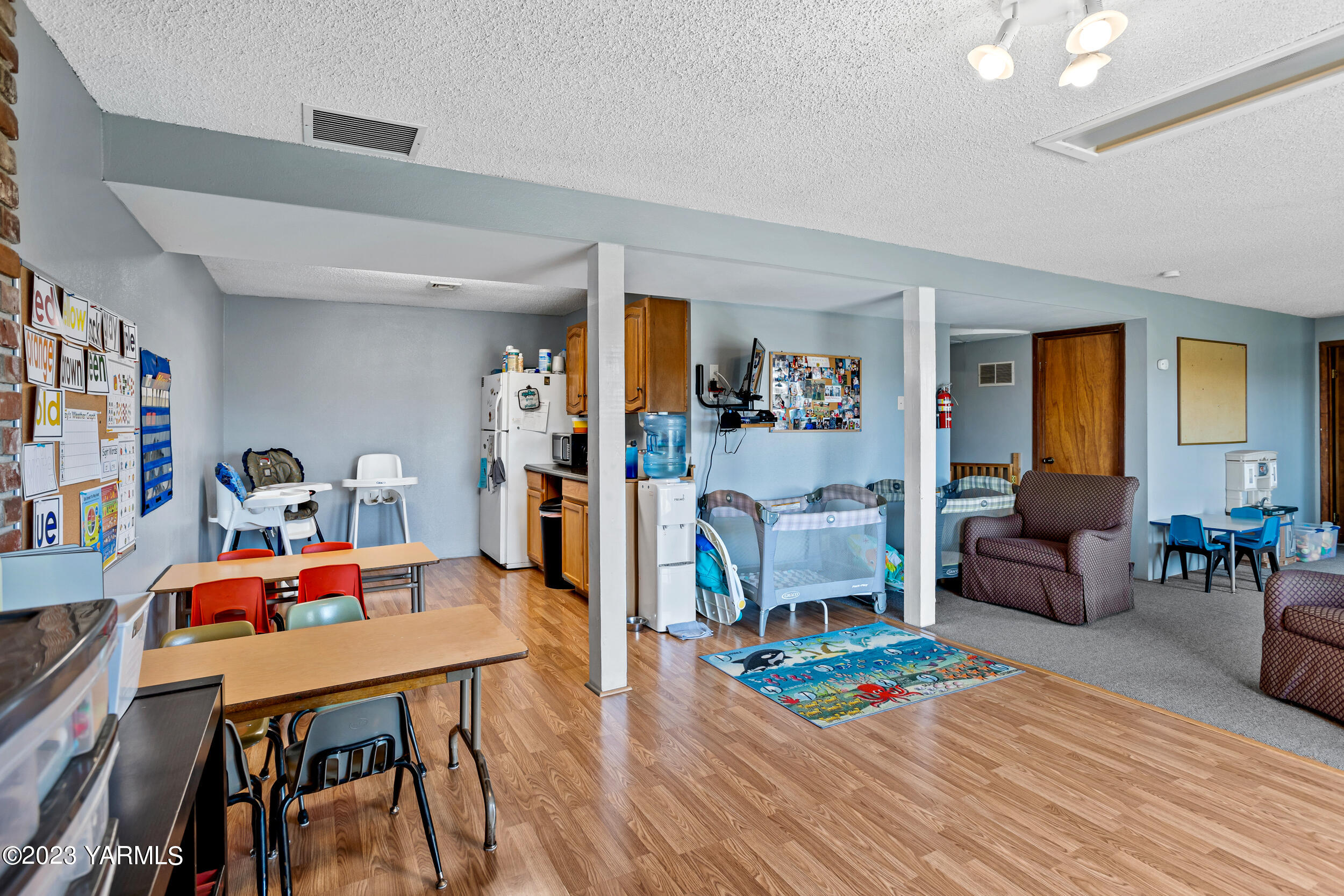 11902 Marble Road Yakima, WA 98908 - Photo 24 of 29 a living room with furniture and a dining table with wooden floor