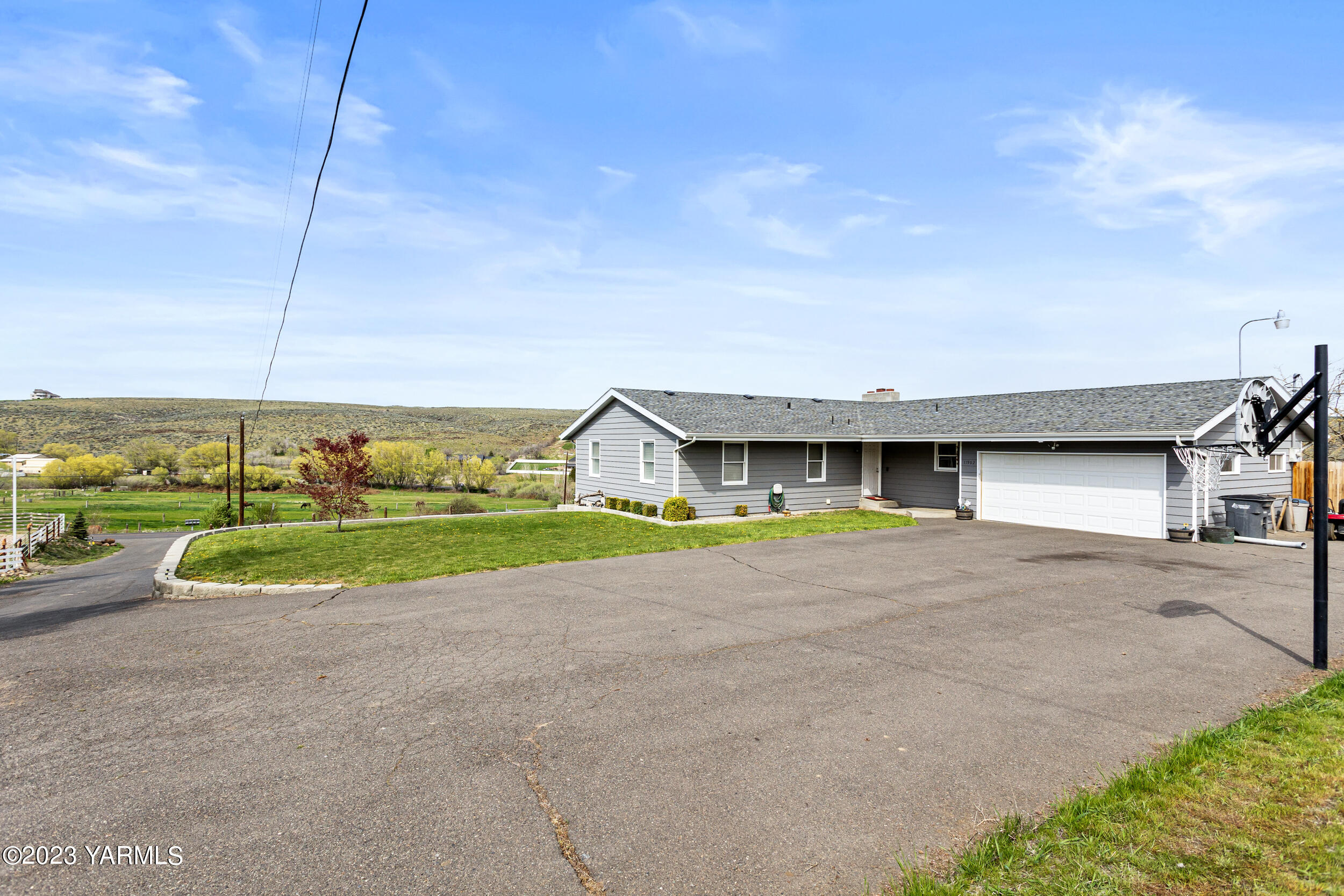 11902 Marble Road Yakima, WA 98908 - Photo 3 of 29 a view of a house with a yard and garage