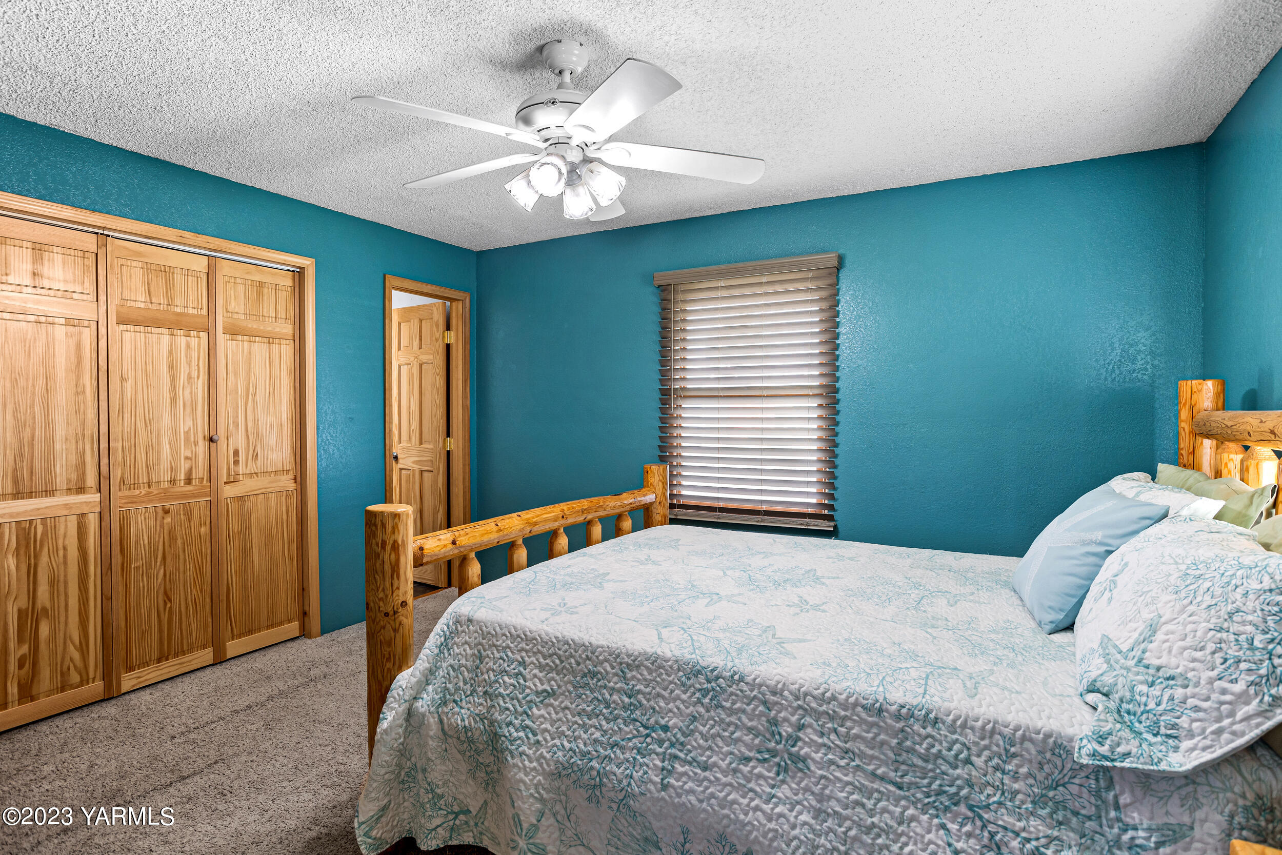 11902 Marble Road Yakima, WA 98908 - Photo 10 of 29 a bedroom with a bed and a chandelier