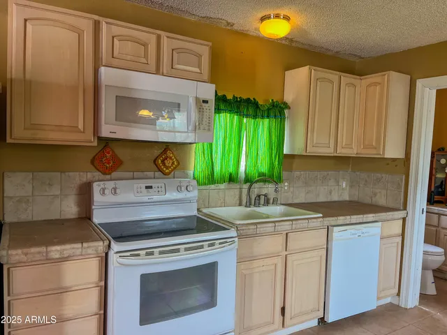 a kitchen with a stove top oven sink and cabinets