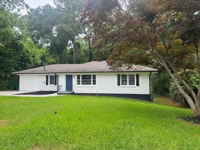 4286 Welbron Drive Decatur, GA 30035 - Photo 1 of 1 a house that is sitting in the grass with large trees and plants