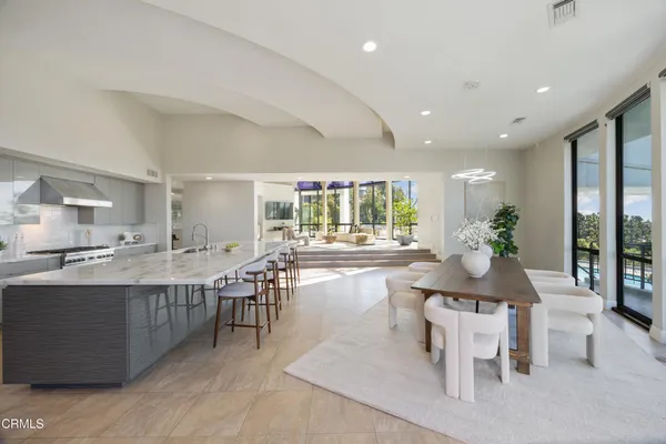 a living room with kitchen island furniture and a wooden floor