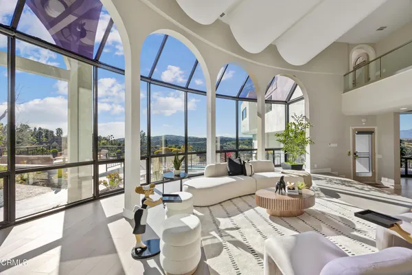a spacious bedroom with a bed and large windows