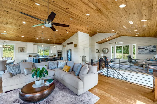 a living room filled with furniture hardwood floor and a large window