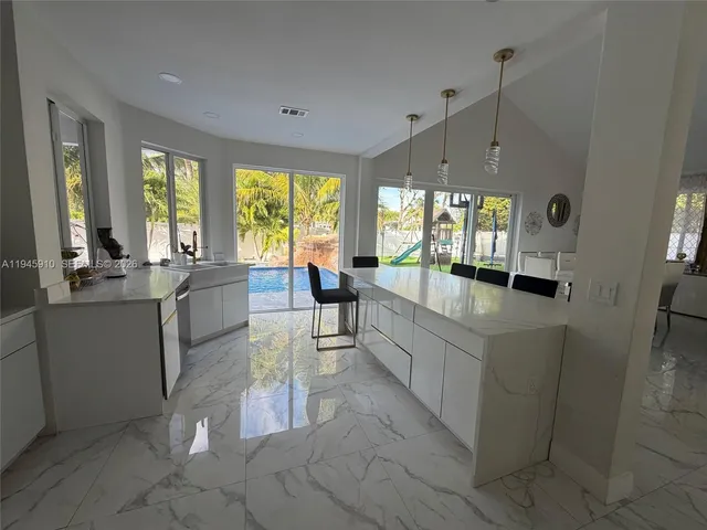 a kitchen with stainless steel appliances granite countertop a sink and a cabinets