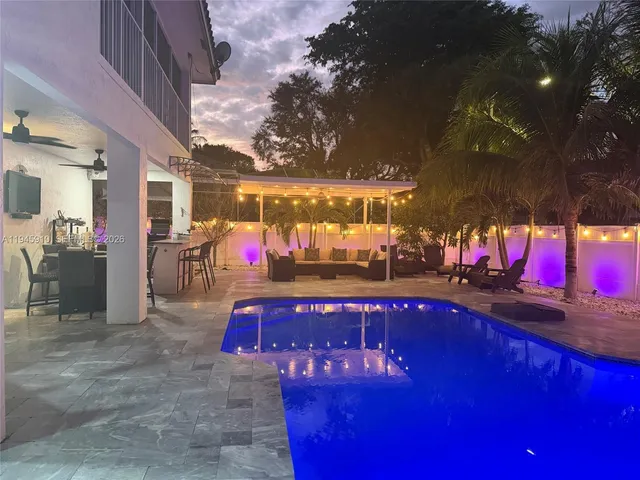 a view of swimming pool with red chairs