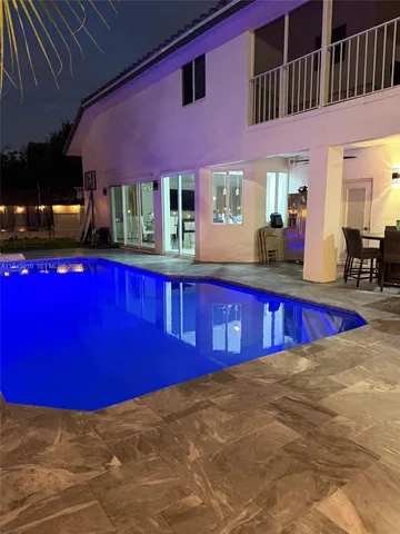 a view of swimming pool with outdoor seating