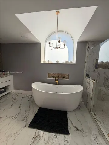 a view of a livingroom with wooden floor and stairs