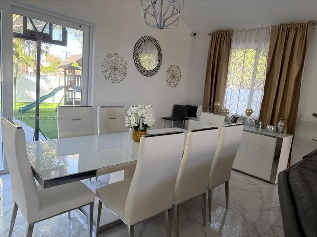 a dining room with furniture and window