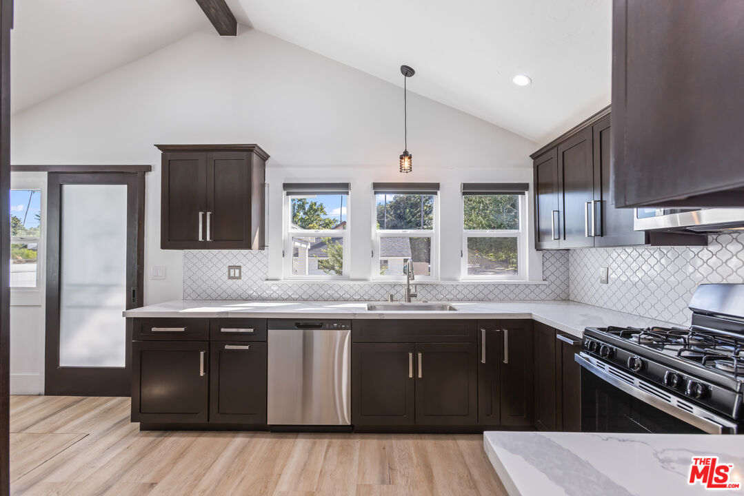 150 Dearborn Street Pasadena, CA 91103 - Photo 3 of 4 a kitchen with stainless steel appliances granite countertop a sink stove and refrigerator