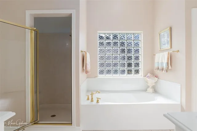 a white bath tub sitting next to a window