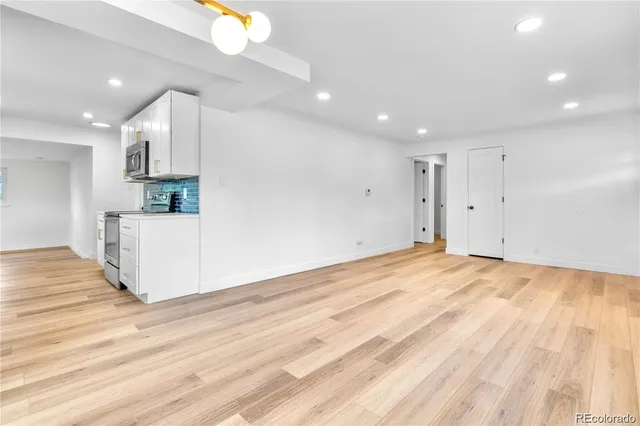 a view of a kitchen with a sink and cabinets