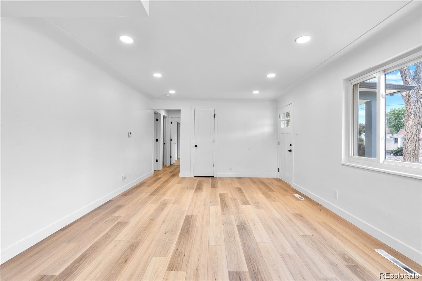 6500 West 32nd Avenue Wheat Ridge, CO 80033 - Photo 11 of 39 a view of empty room with wooden floor and fan