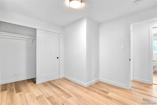 a view of an empty room and wooden floor