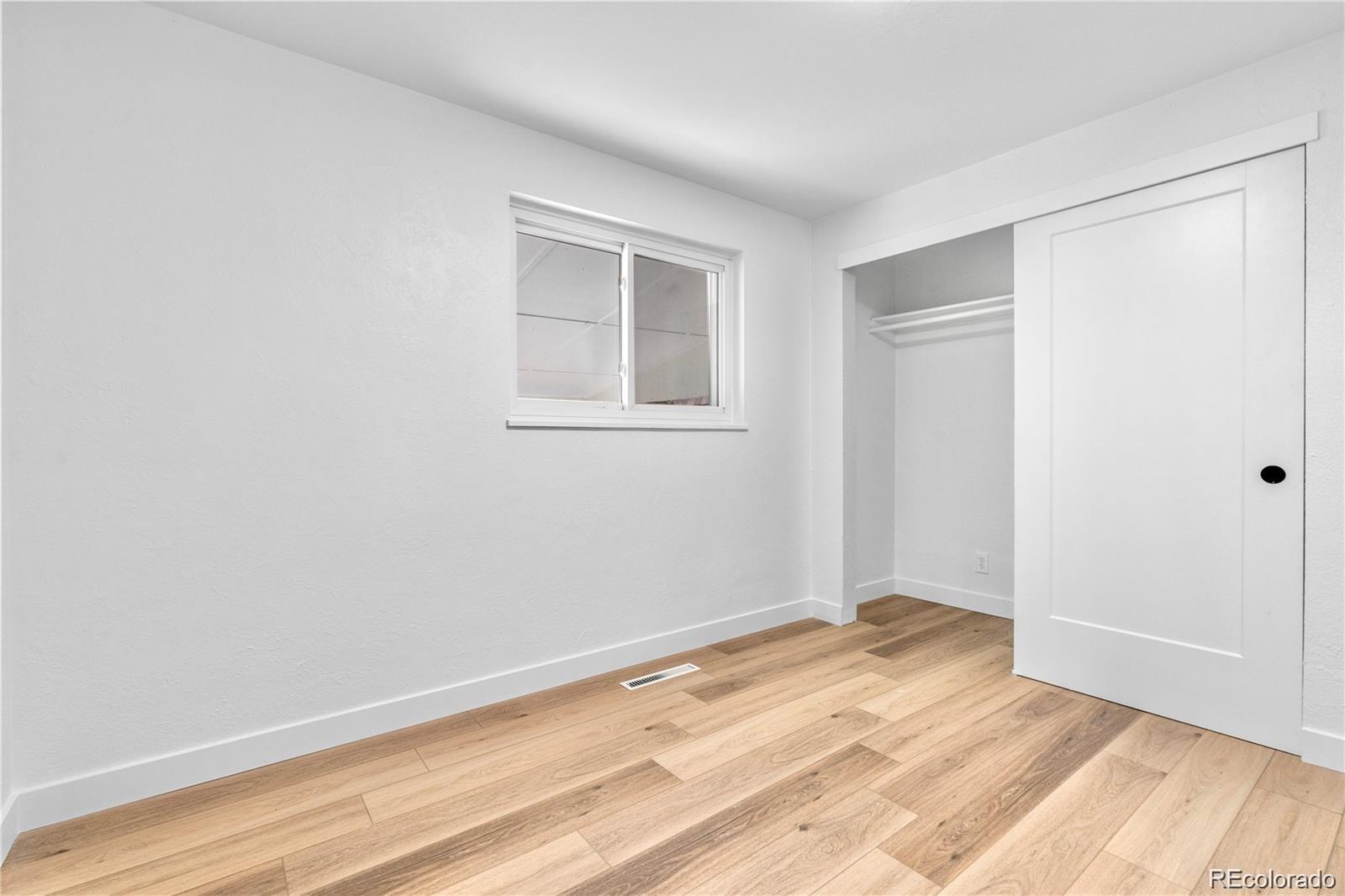 6500 West 32nd Avenue Wheat Ridge, CO 80033 - Photo 16 of 39 a view of an empty room with wooden floor and a window