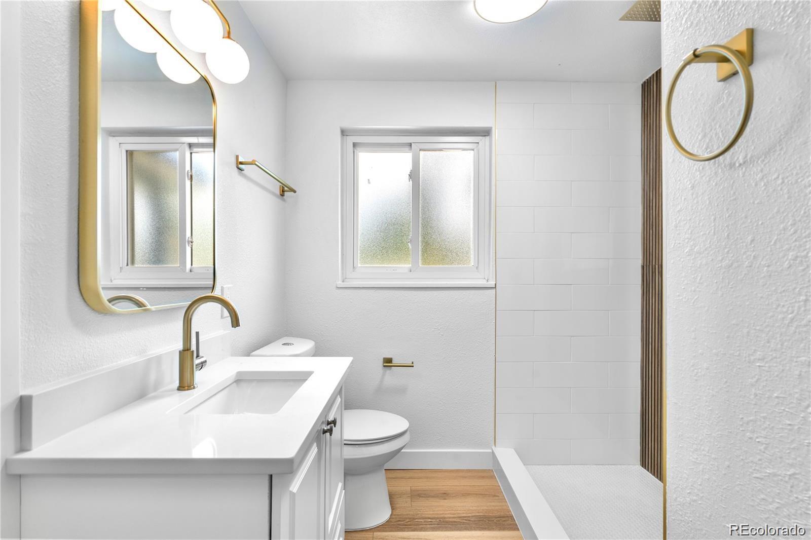 6500 West 32nd Avenue Wheat Ridge, CO 80033 - Photo 18 of 39 a bathroom with a sink toilet and shower