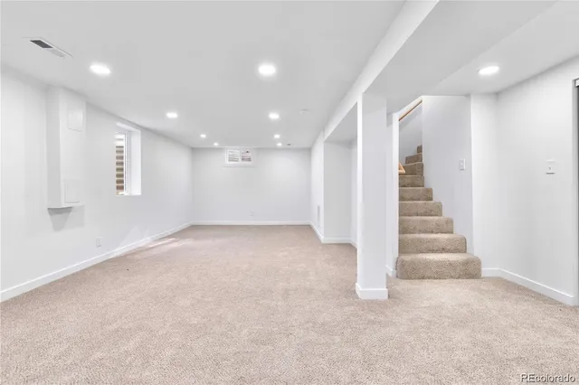 a view of an empty room with stairs