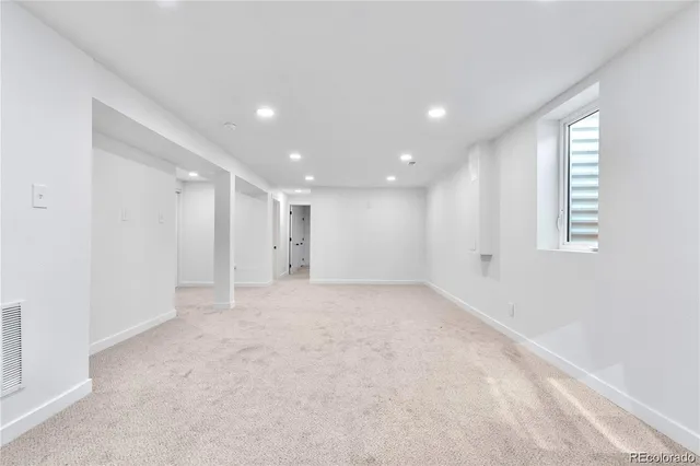 an empty room with windows and closet