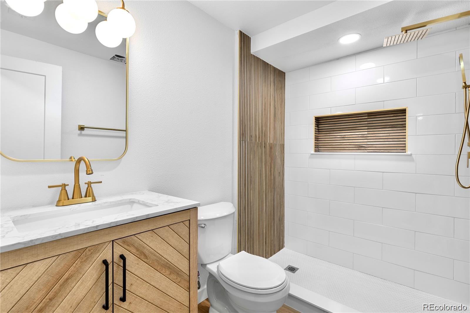 6500 West 32nd Avenue Wheat Ridge, CO 80033 - Photo 27 of 39 a bathroom with a sink a toilet and shower