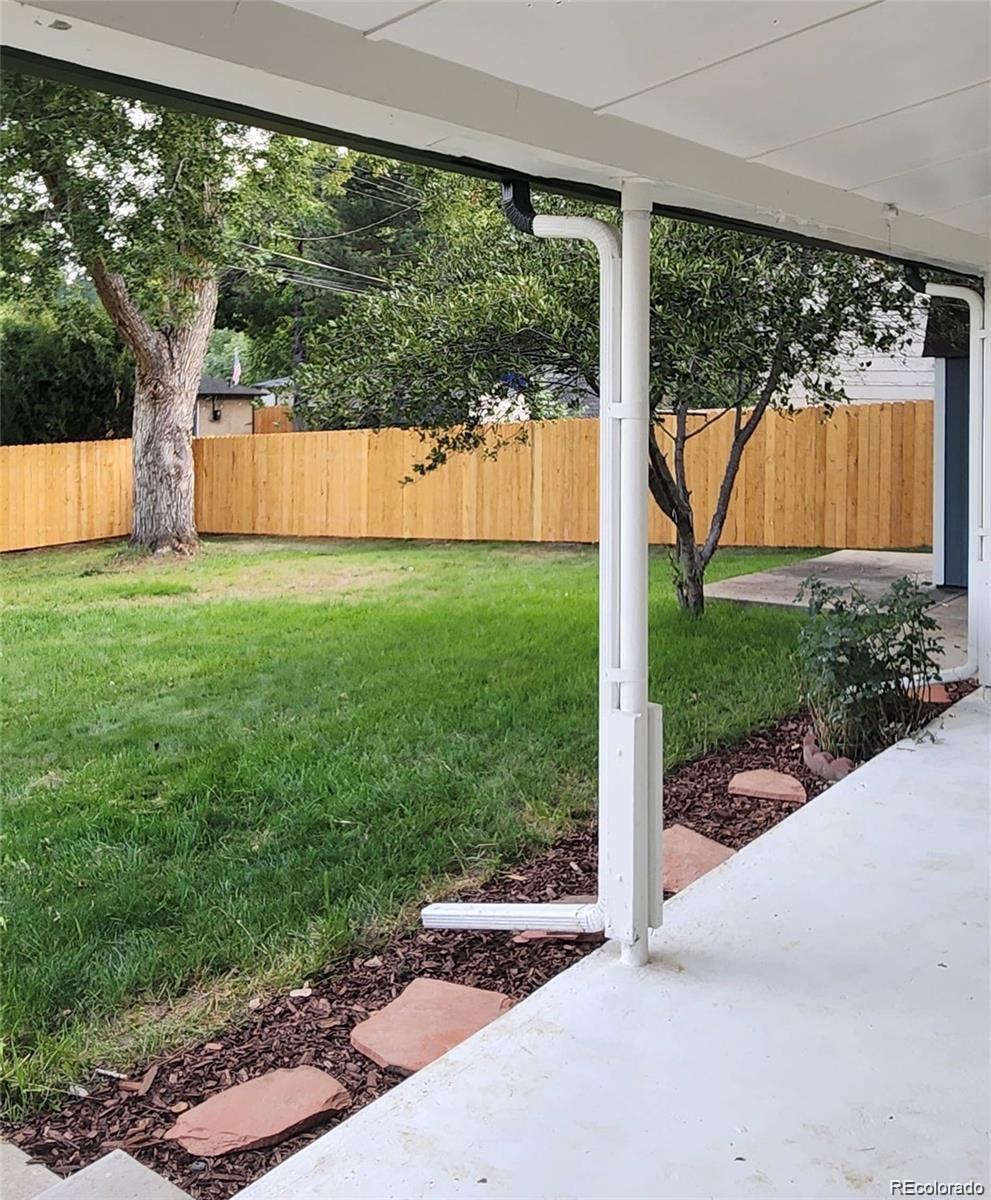 6500 West 32nd Avenue Wheat Ridge, CO 80033 - Photo 34 of 39 a view of backyard with large tree and a yard