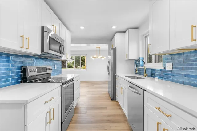 a kitchen with stainless steel appliances granite countertop a sink stove and cabinets