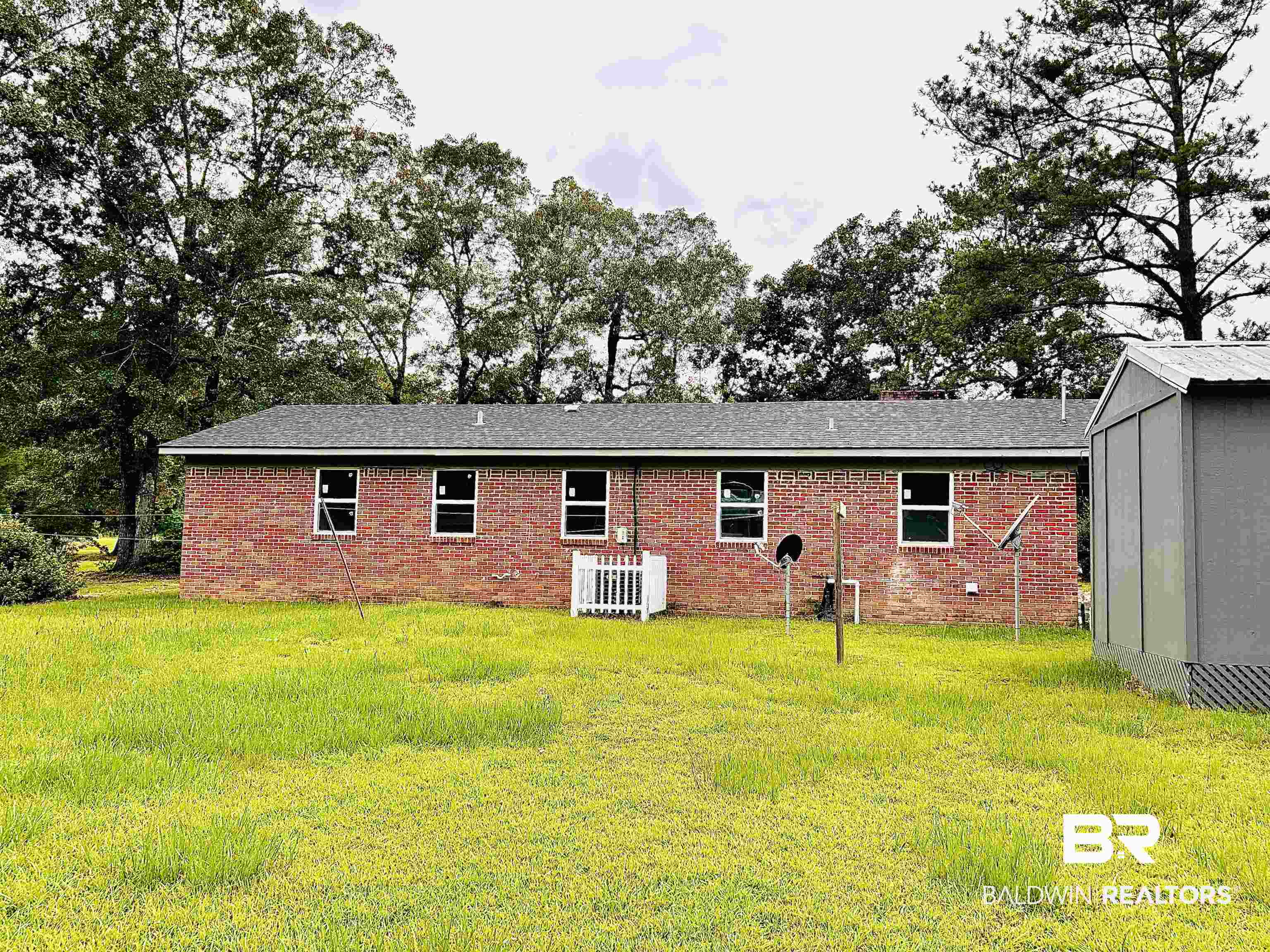 7870 Bradley Road Brewton, AL 36426 - Photo 7 of 8 Brick exterior residence with a dark shingle roof