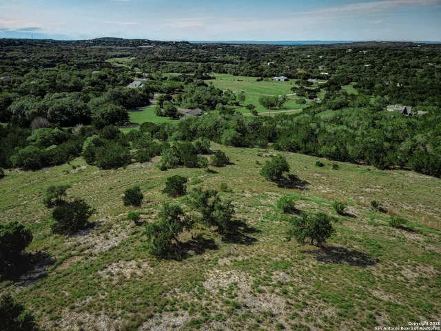 an aerial view of a houses with a yard