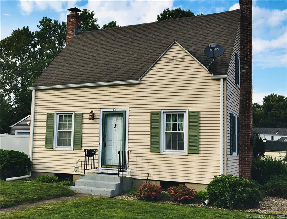 a view of a house with a yard and potted plants