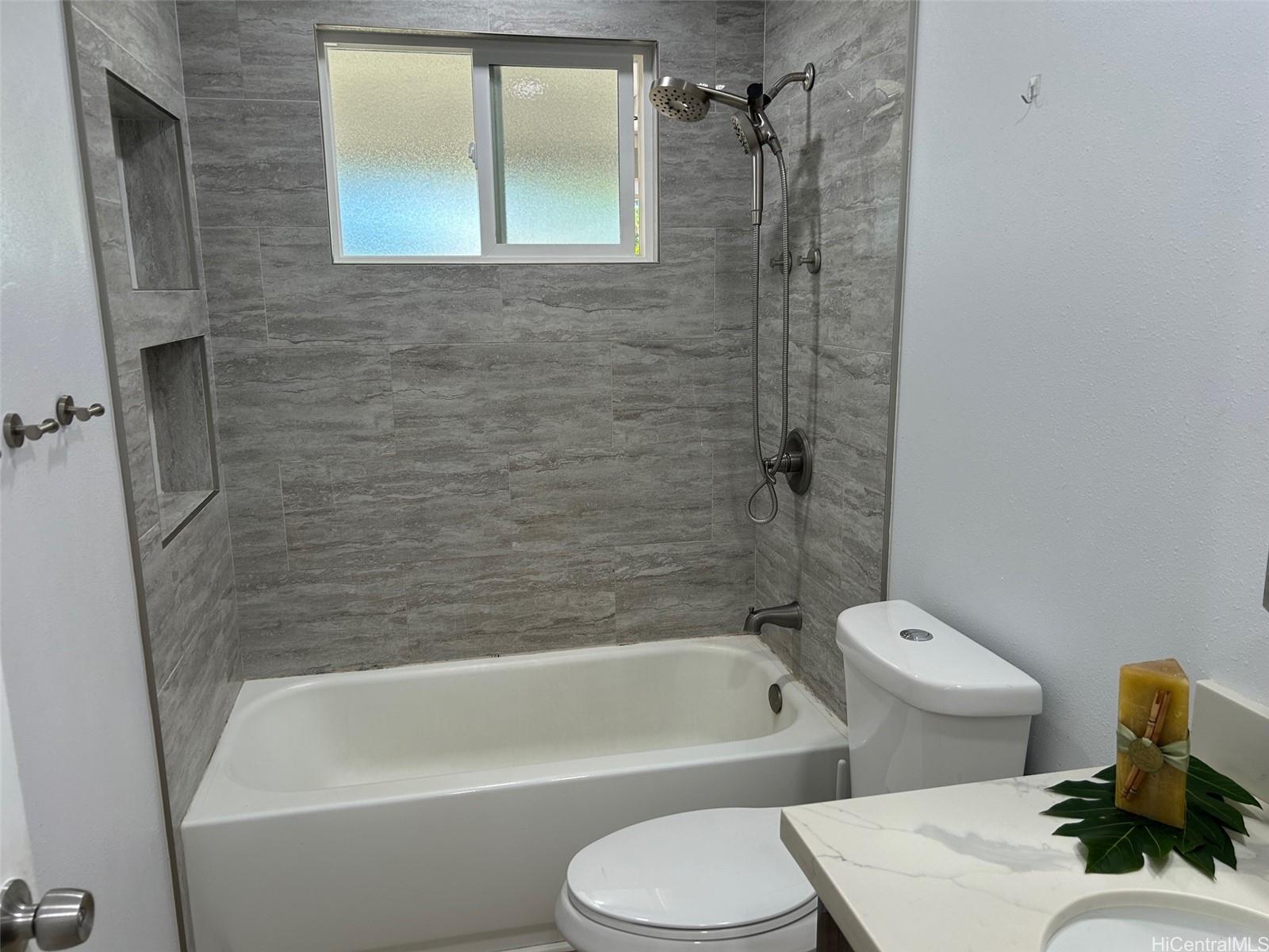 84-116 Kapakai Place Waianae, HI 96792 - Photo 12 of 14 a bathroom with a toilet and a bathtub