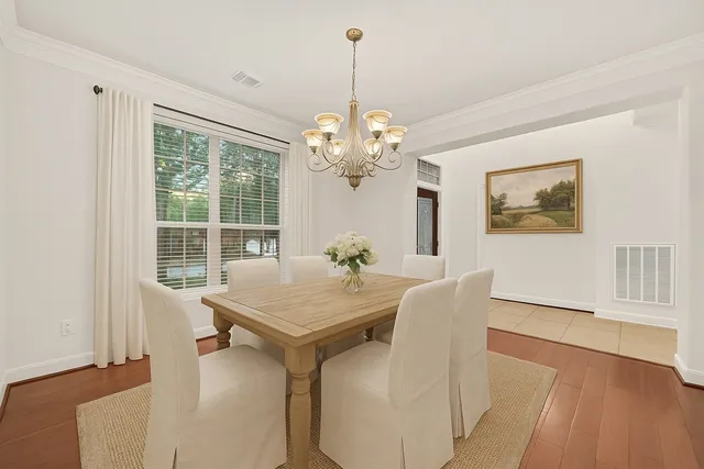 a kitchen with a sink cabinets and wooden floor