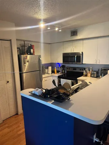 a room with furniture a refrigerator and a sink