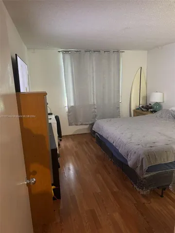 a bedroom with a bed and a chair