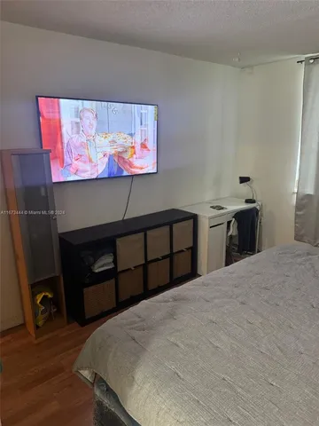 a bedroom with a bed and the wall painting