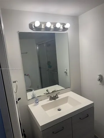 a bathroom with a sink and a mirror