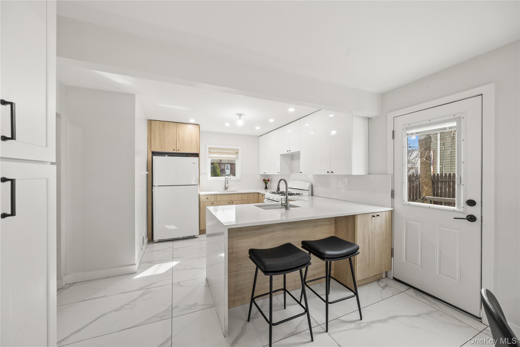 10 Sneden Court Spring Valley, NY 10977 - Photo 19 of 42 a kitchen with kitchen island a appliances dining table and chairs