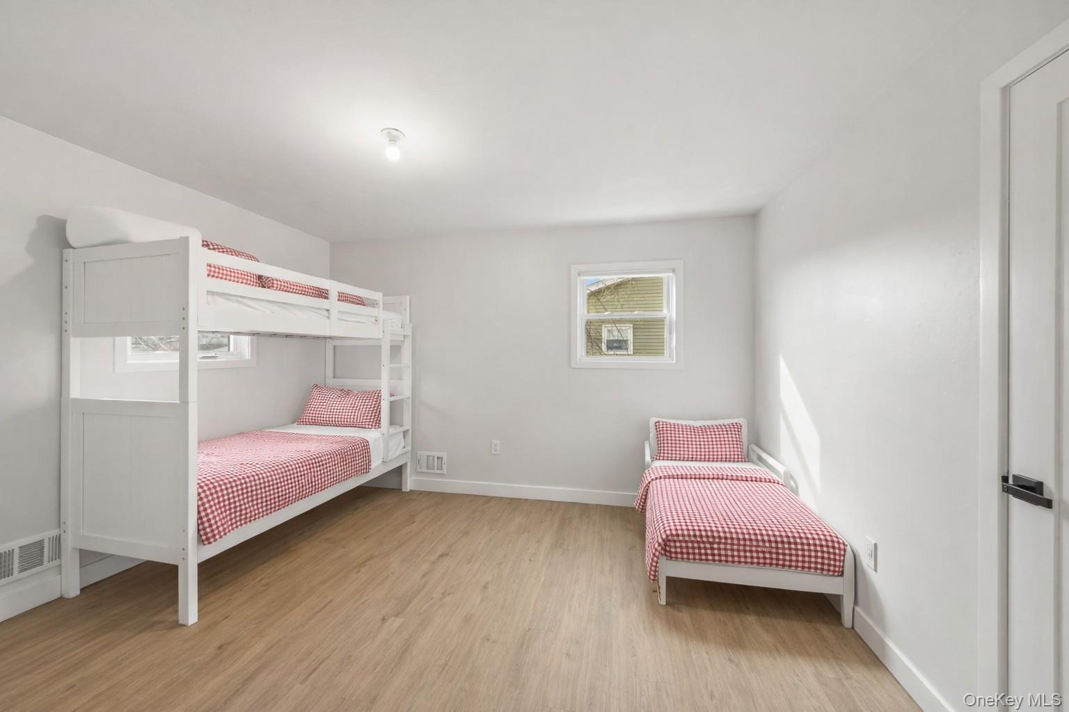 10 Sneden Court Spring Valley, NY 10977 - Photo 28 of 42 a bedroom with a bed and a chair