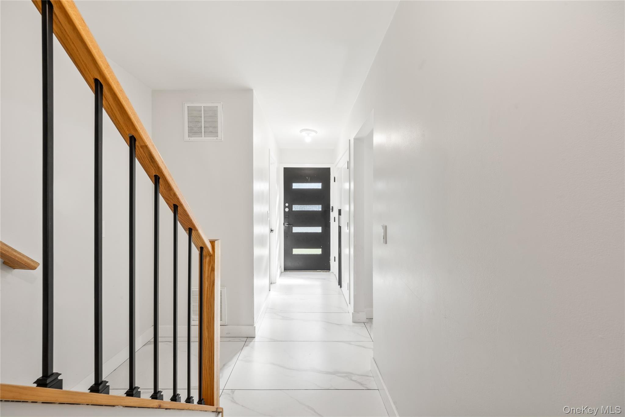 10 Sneden Court Spring Valley, NY 10977 - Photo 6 of 42 a view of a hallway with wooden floor and staircase