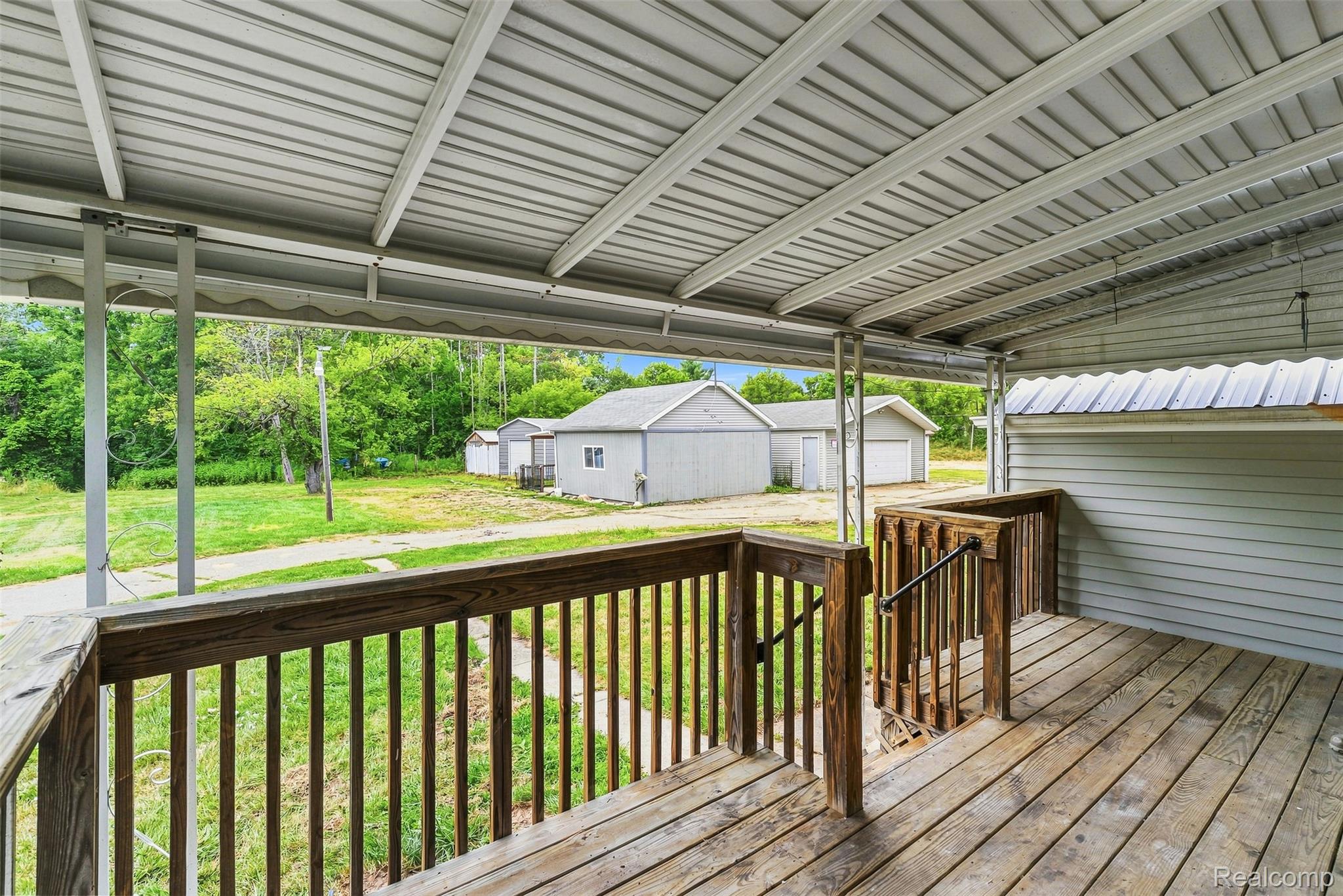 6163 North State Road Davison, MI 48423 - Photo 33 of 45 Covered porch with wood-finish decking and railing