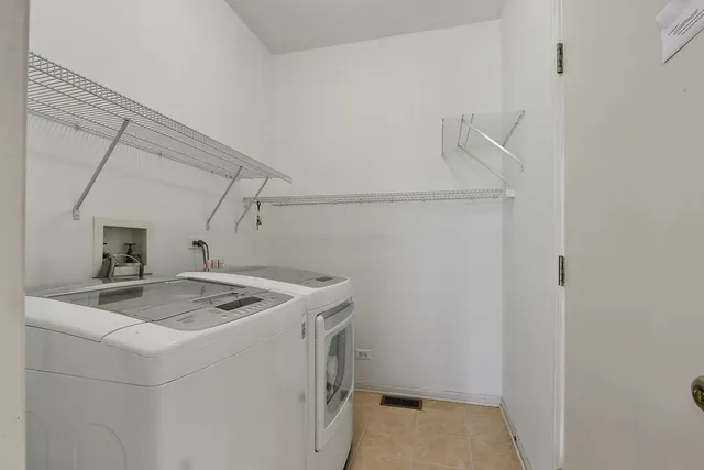 a utility room with dryer and sink