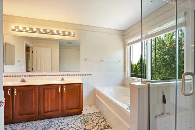 a bathroom with a sink a vanity and a bathtub