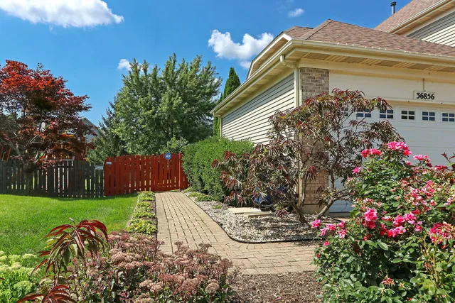 a view of a house with a yard and garden