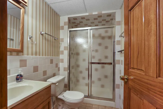 a bathroom with a sink toilet and shower